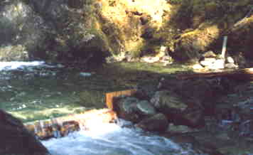 The weir we built to measure flow. The probe is visible in the top right corner of the photo. It was positioned below water, and level with the bottom of the weir. Data was automatically sent by low power HF radio to Vancouver on a daily basis.